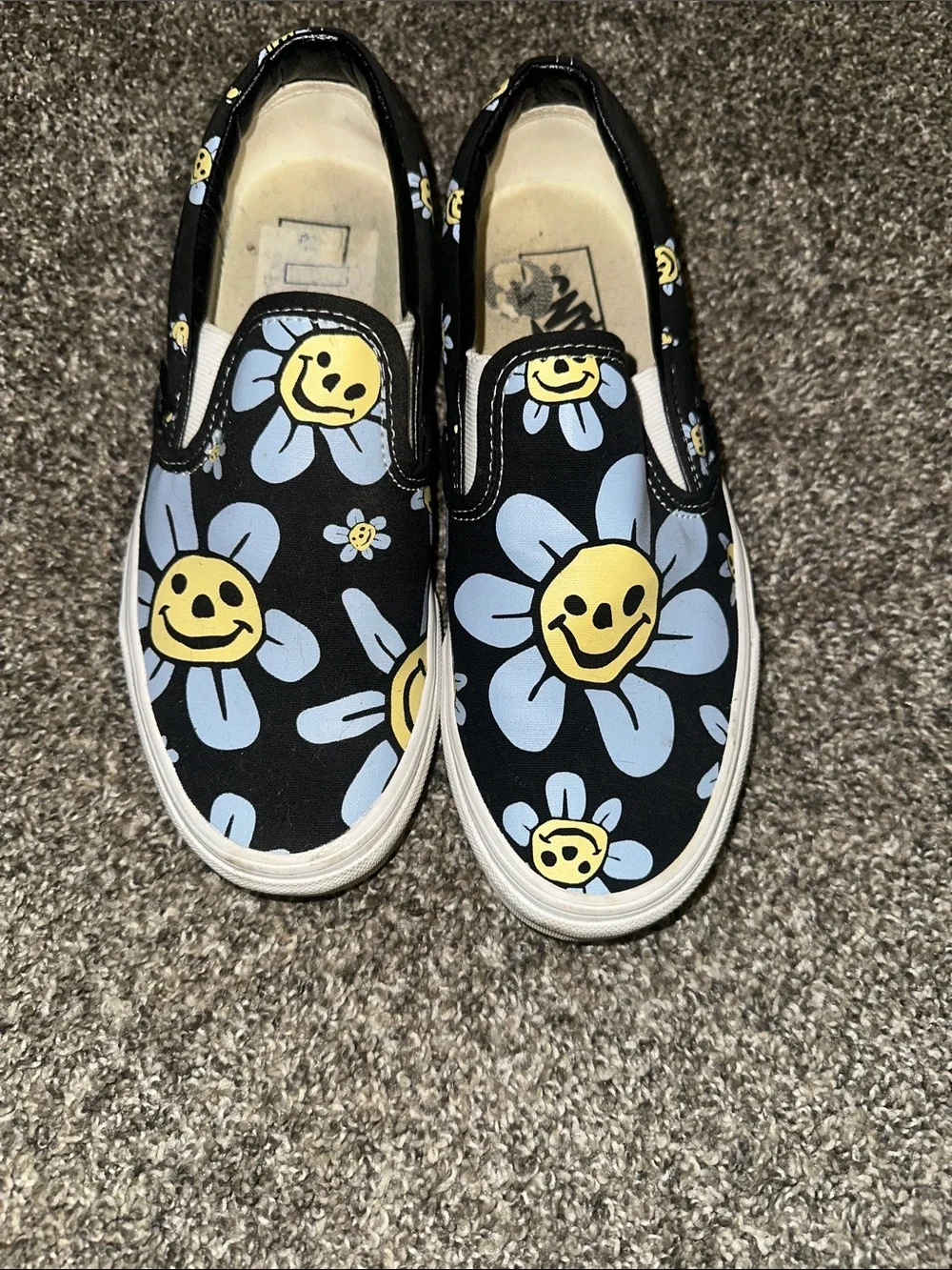 Vans Black Slip-On Sneakers with Yellow & Light Blue Daisy Smiley Print